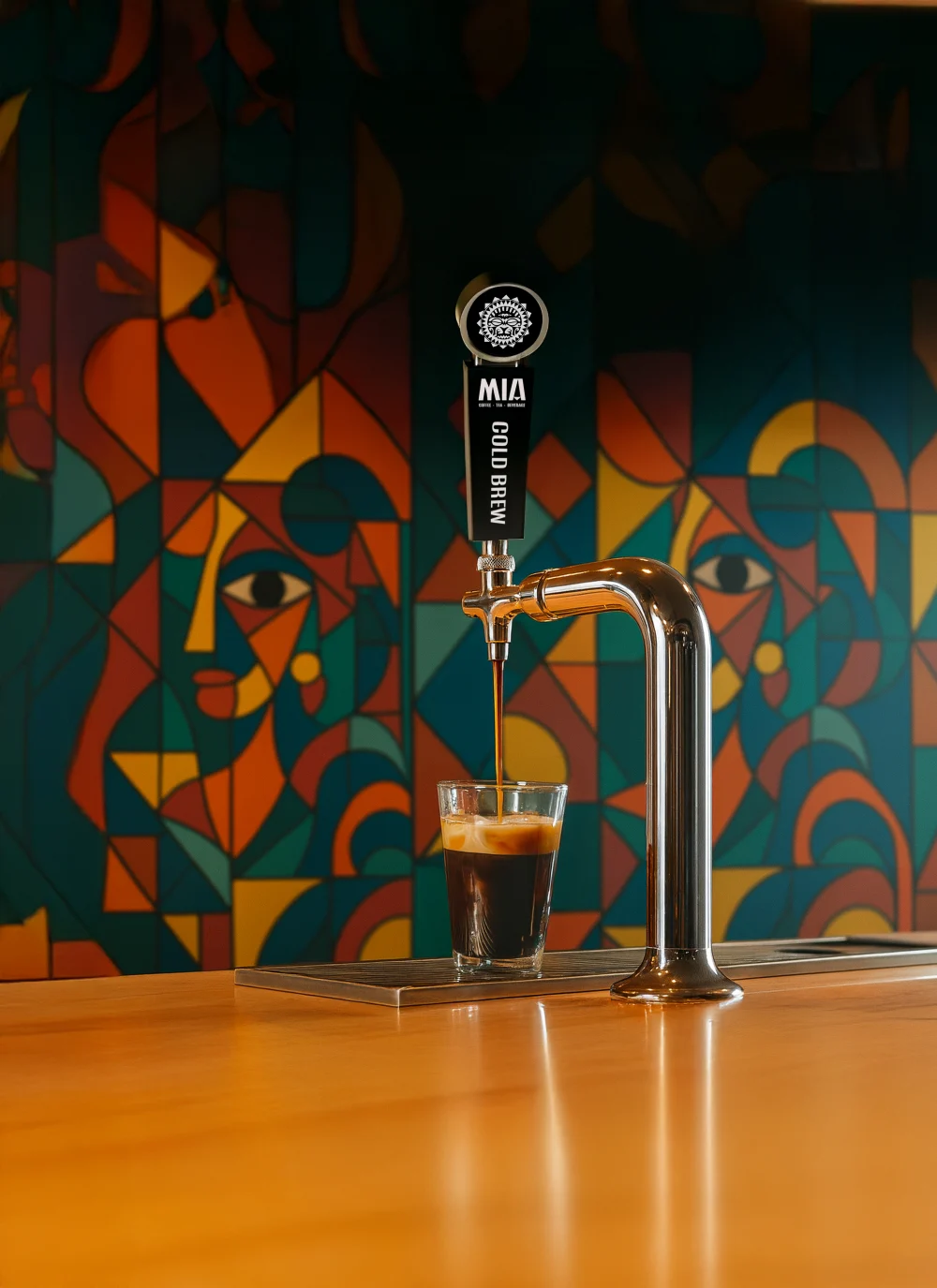 Mia Cold Brew pouring from a branded tap into a glass against a colorful Cubist mural — hospitality service