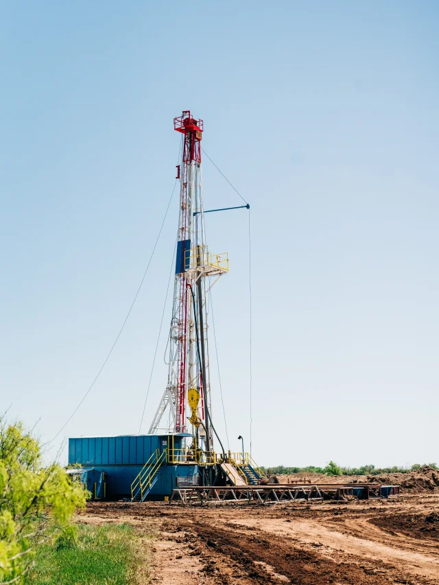 A Pure Oil drilling rig standing against a clear sky