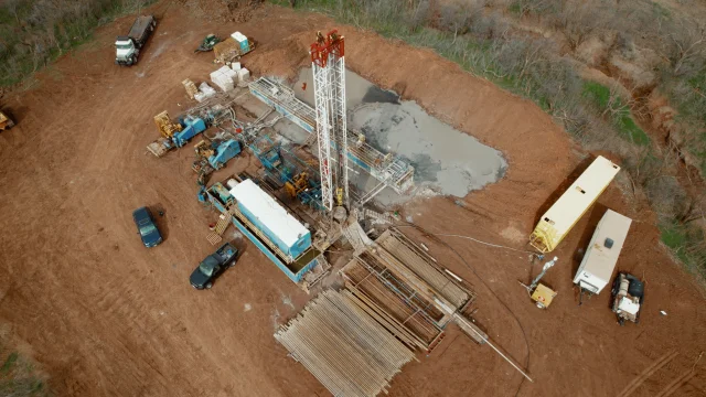 Aerial view of a Pure Oil drilling site set in open Texas farmland