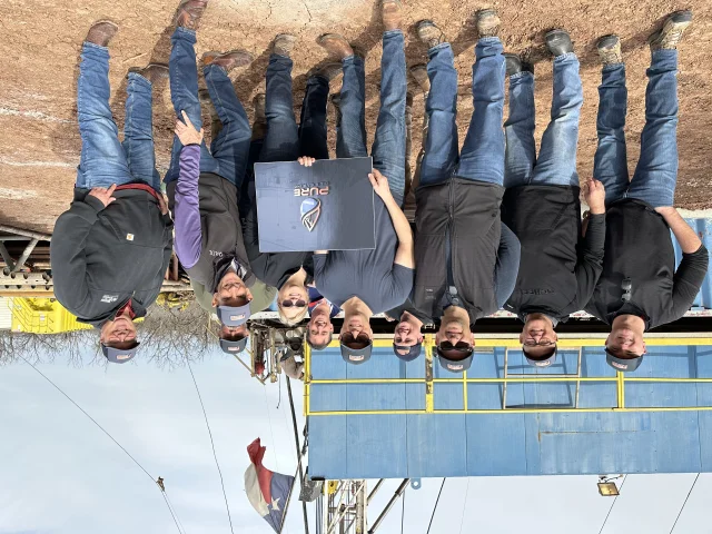 Pure Oil & Gas investor trip group photo on site